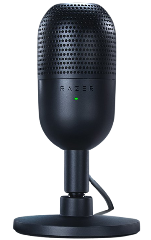 Microphone USB Razer Seiren V3 Mini posé sur un socle au centre d’une scène éclairée, entouré de fumée et mis en avant par un projecteur, avec encart bleu vantant son ultra-compacité pour le streaming et le gaming.